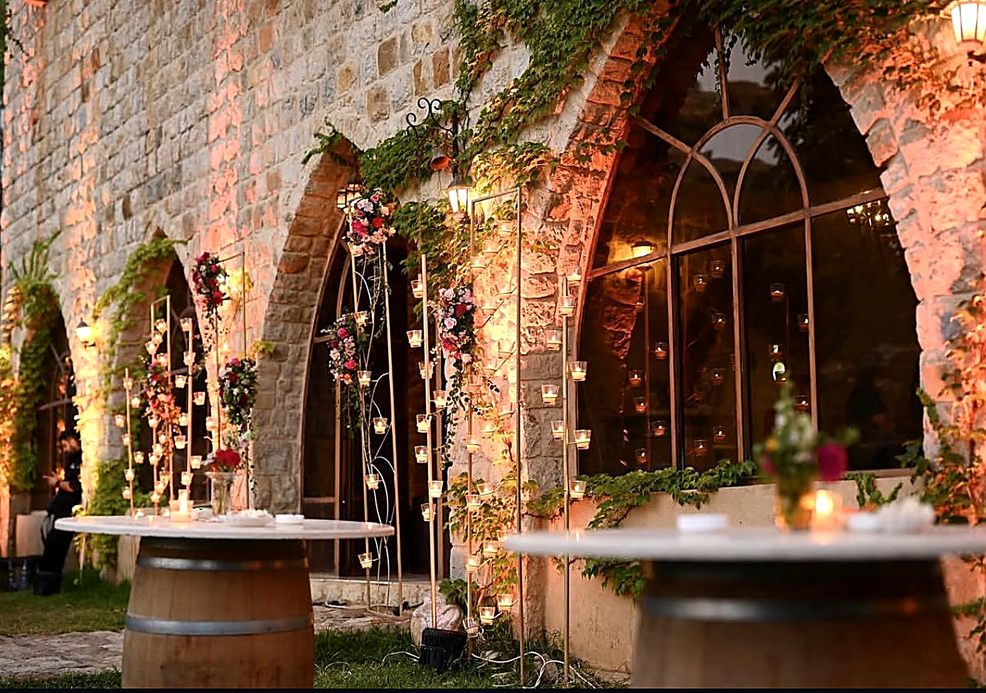 Candlelit stone arches with florals at the wedding venue in Bhamdoun, Lebanon